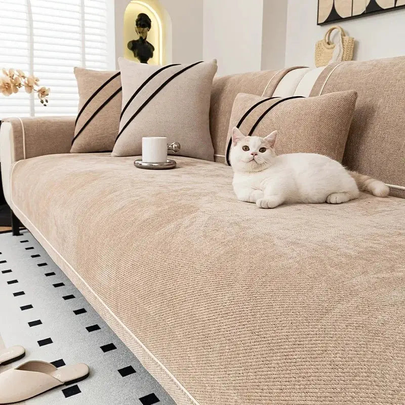 Heavy non-slip sofa protector classic by Simples Market in beige chenille with stitched border on a sofa.