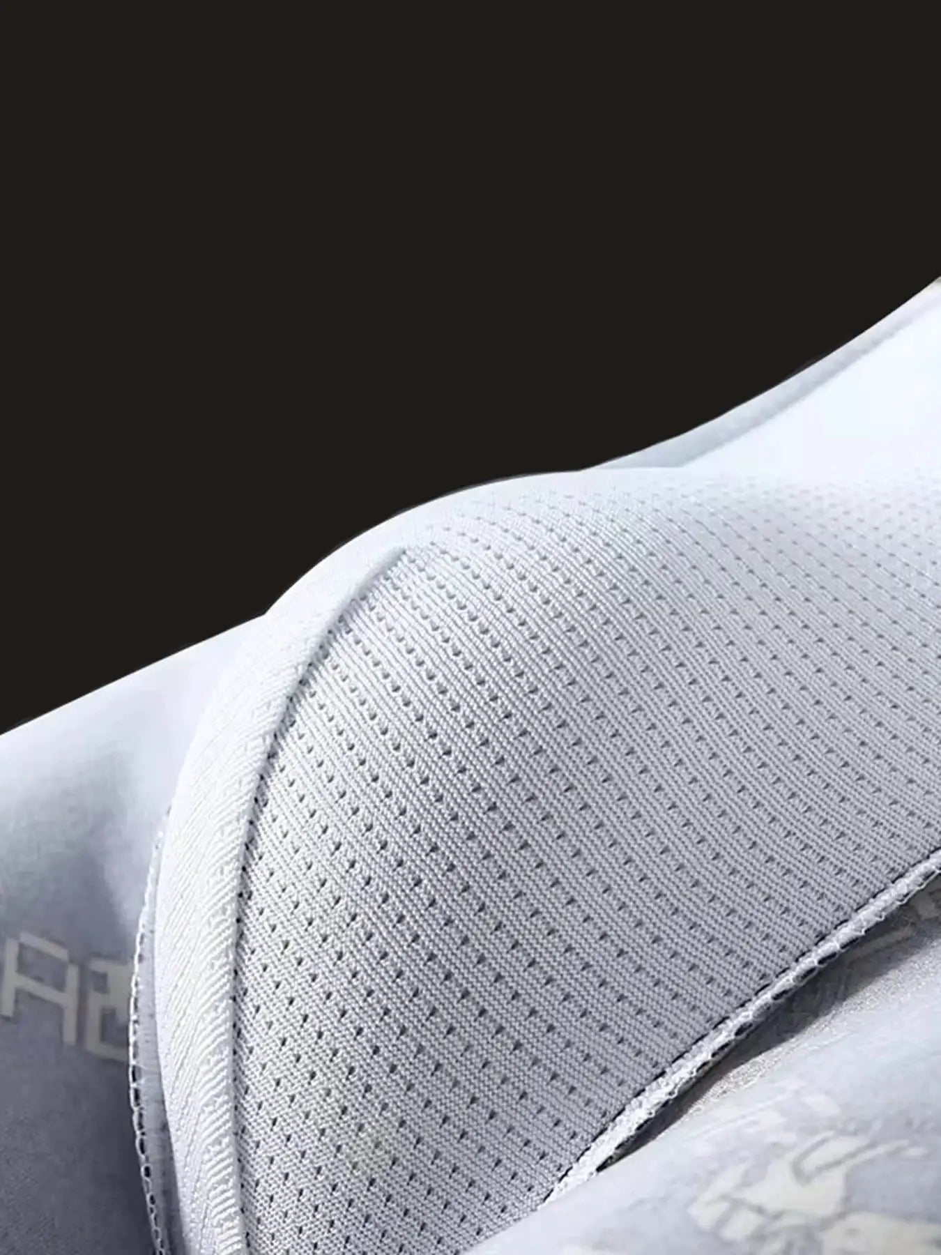 Men's breathable boxer shorts fabric close-up in light gray perforated mesh