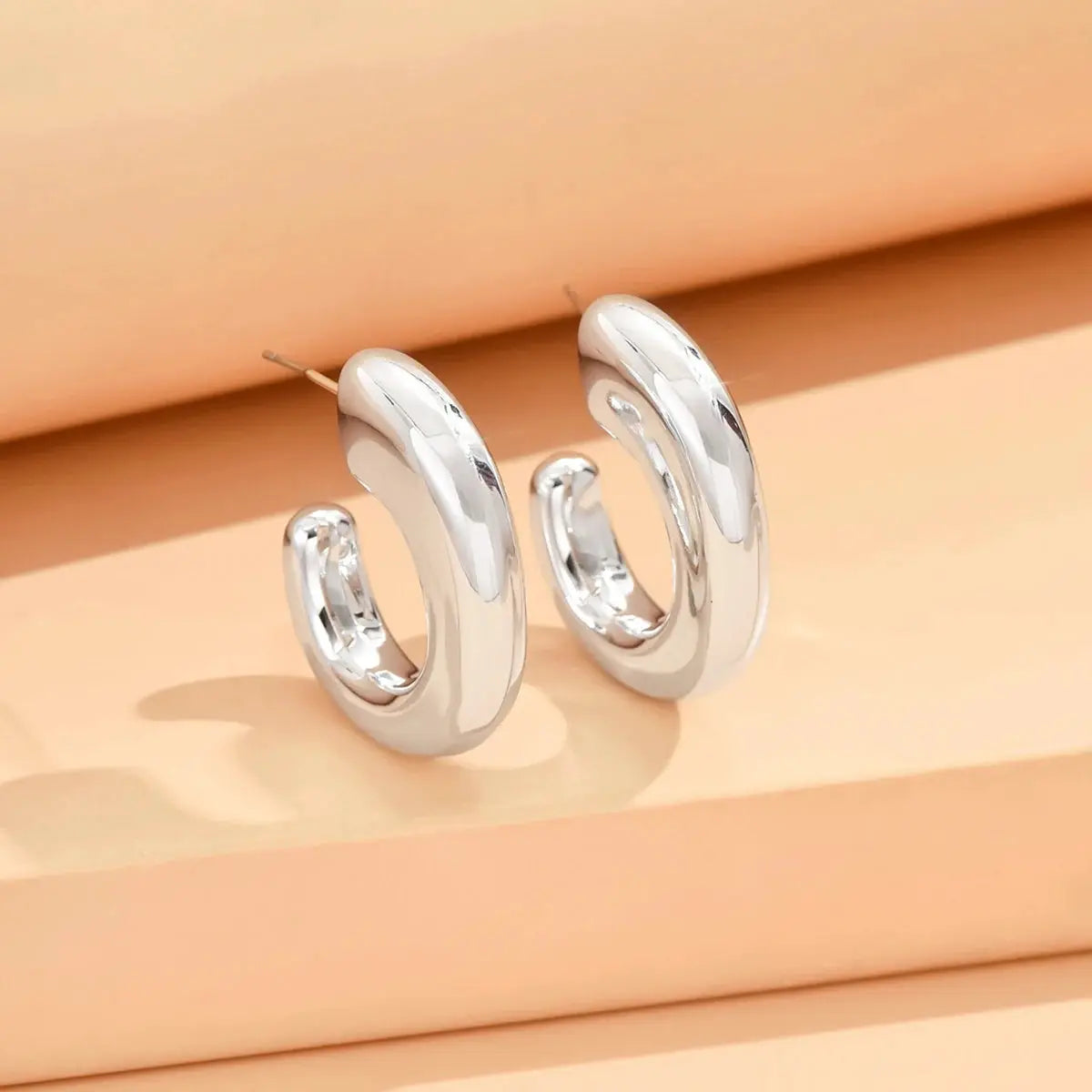 Geometric irregular silver hoop earrings for women, minimalist metallic finish