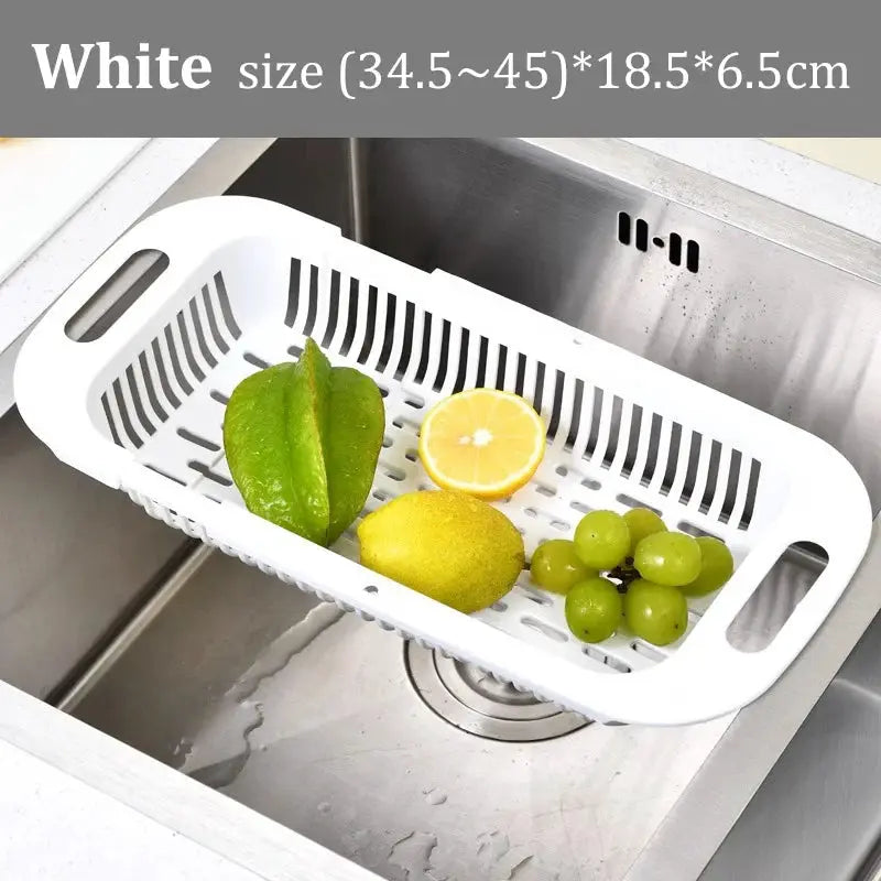 Kitchen sink drain basket white with handles holding lemons and grapes