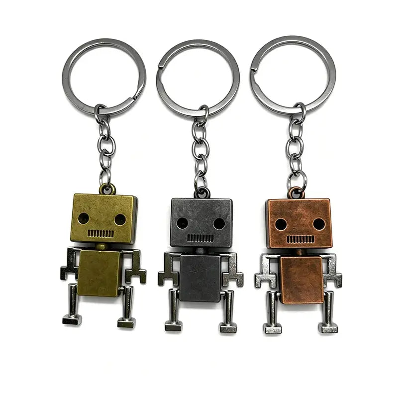 Retro movable robot keychains, 3-piece set in gold, black, and copper metal tones with rings.
