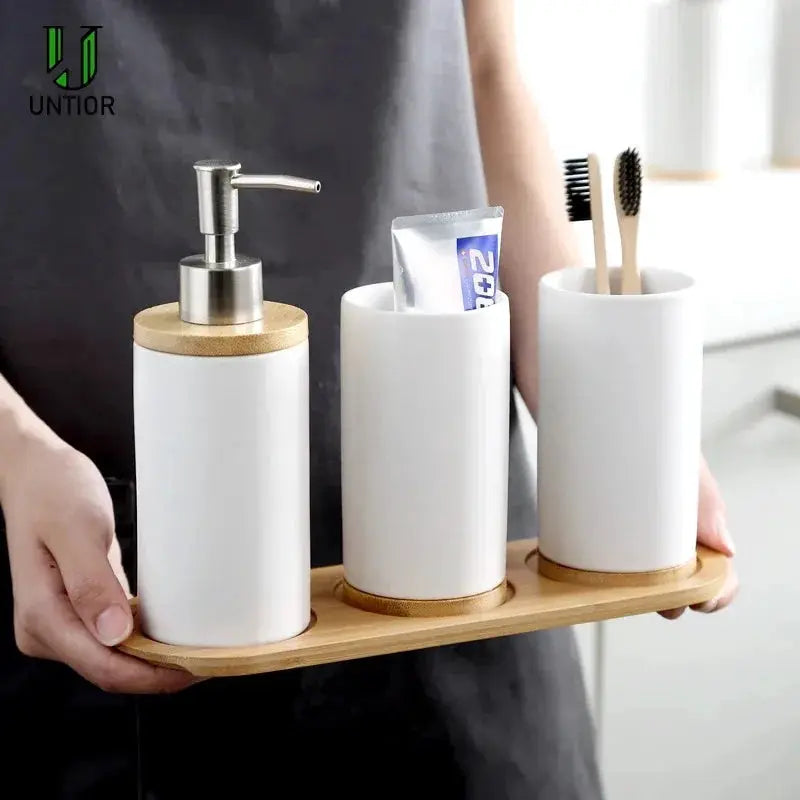 Simples Market white ceramic bathroom accessories set—soap dispenser, toothbrush holder, and tumbler on a bamboo tray