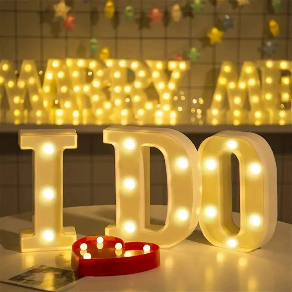 Set of 4 luminous LED letter lamps spelling IDDO with warm white lights for home decor