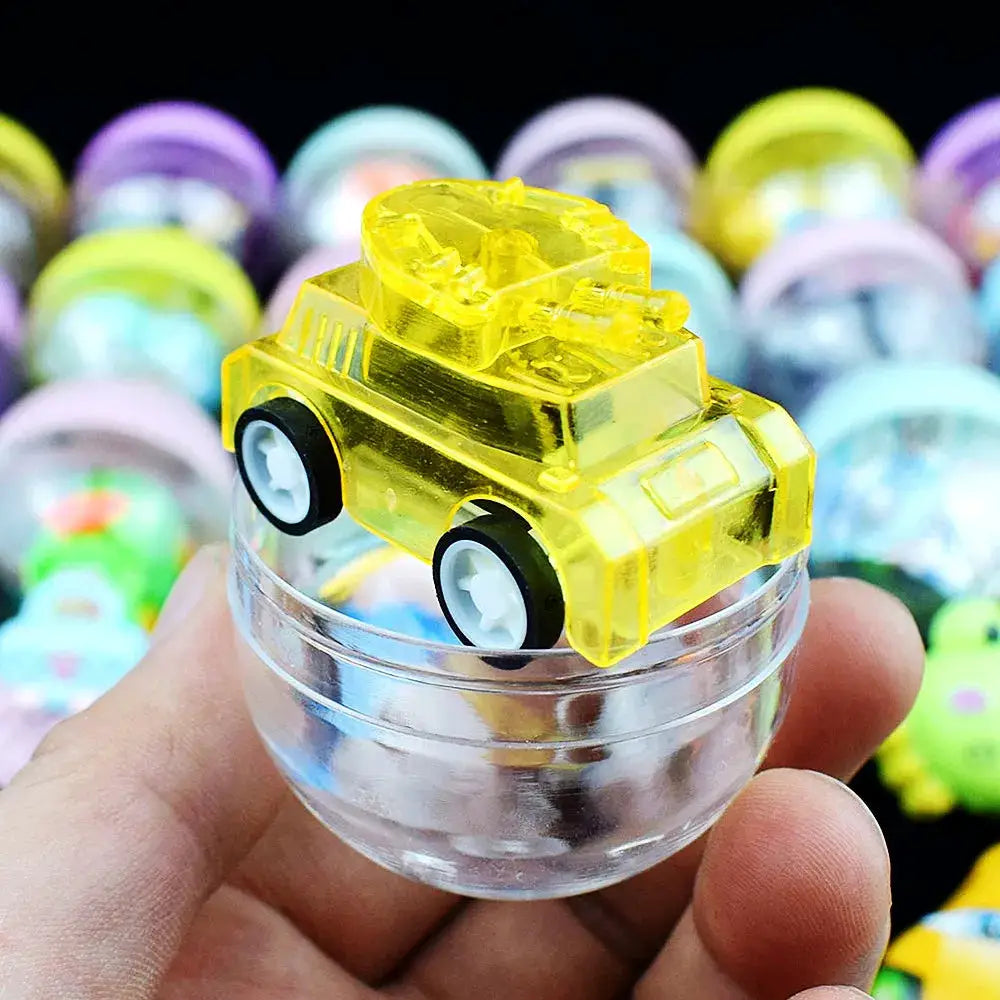 Yellow translucent gacha capsule toy car perched on a clear round capsule; candy-color surprise toy