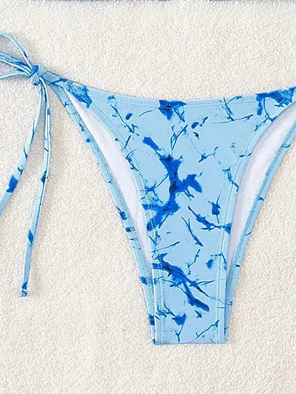 Bikini bottom in light-blue floral print with side ties; Brazilian cut
