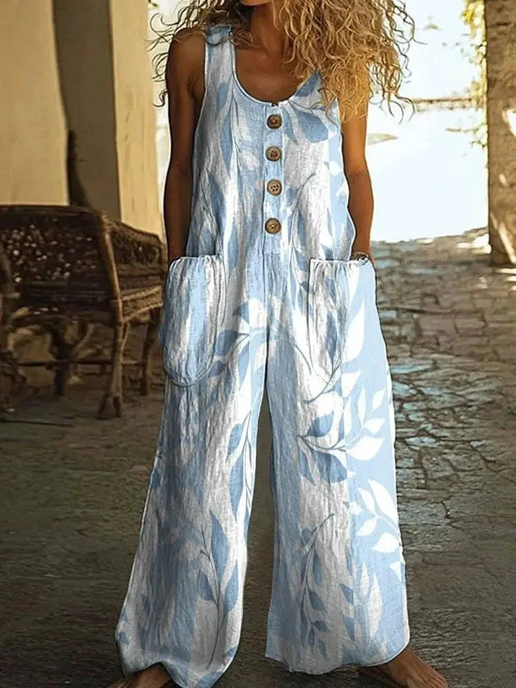 Light blue leaf-print sleeveless jumpsuit for women with front buttons, patch pockets, and wide legs