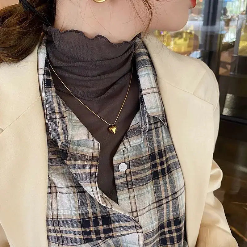 Women's black mesh blouse with plaid shirt and beige blazer; a 3-piece layered outfit