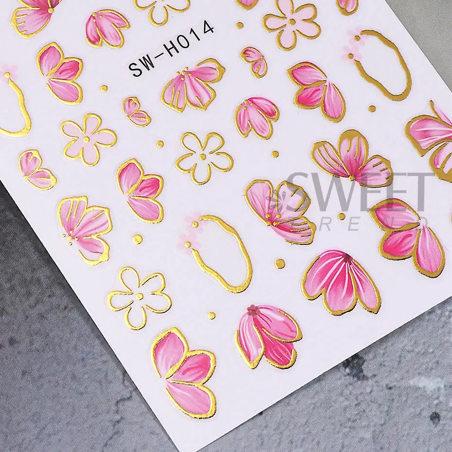 Nail stickers sheet featuring pink hibiscus and floral designs with gold foil borders for DIY manicure
