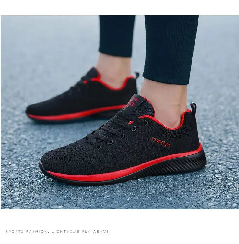 Pair of Simples Market black knit running sneakers with red accents, breathable mesh, lightweight outdoor gym shoes.