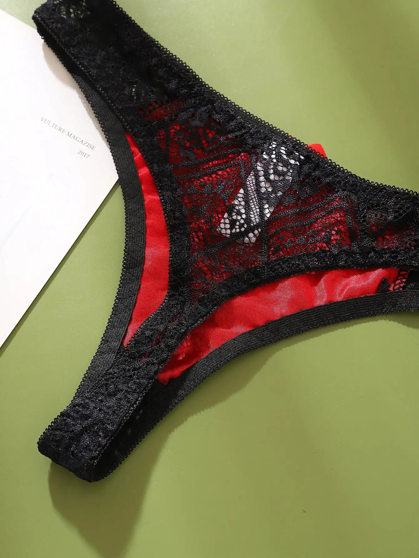 Black lace g-string panties with red satin panel and sheer floral lace details