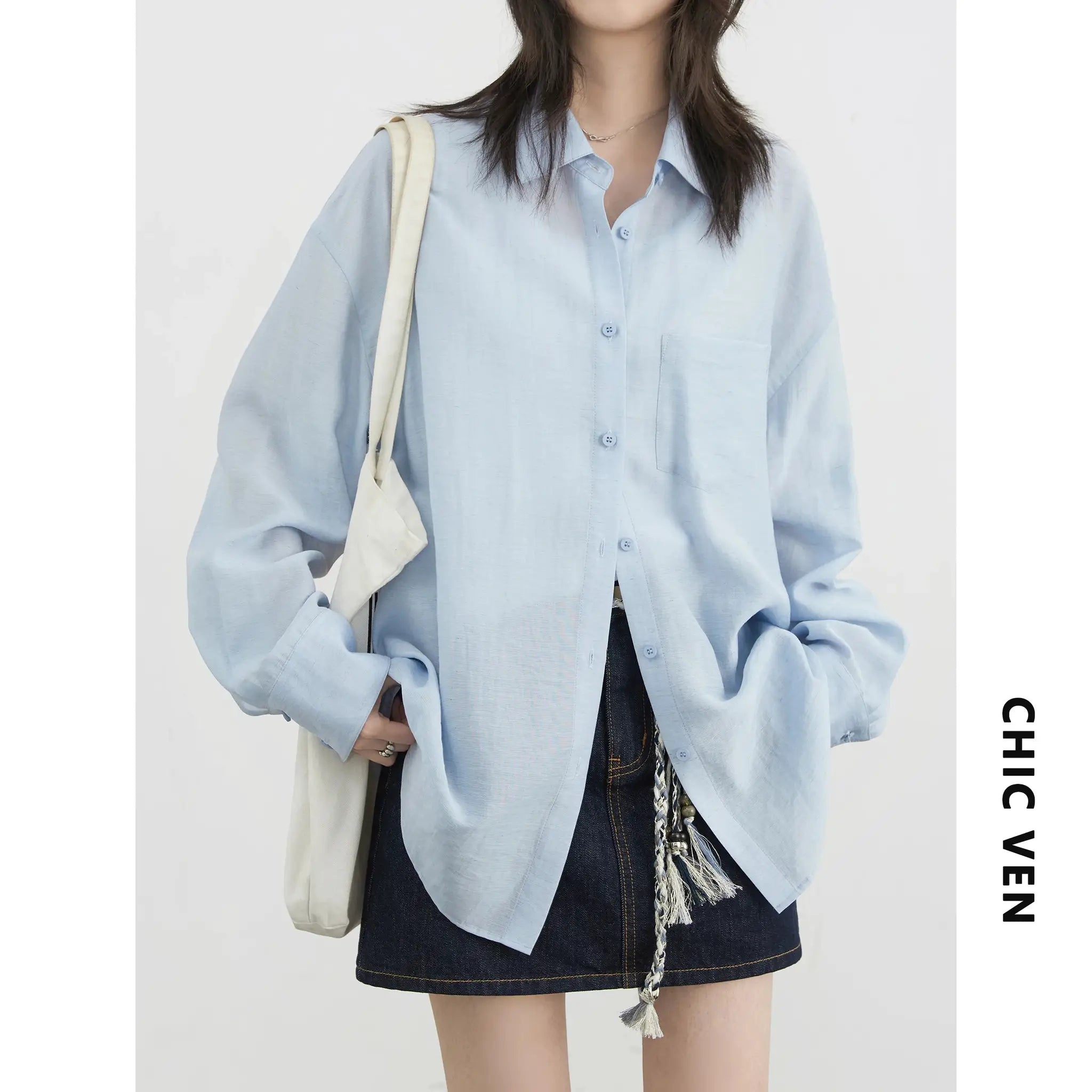 CHIC VEN light-blue loose long-sleeve shirt, button-front with chest pocket, worn with tote bag.