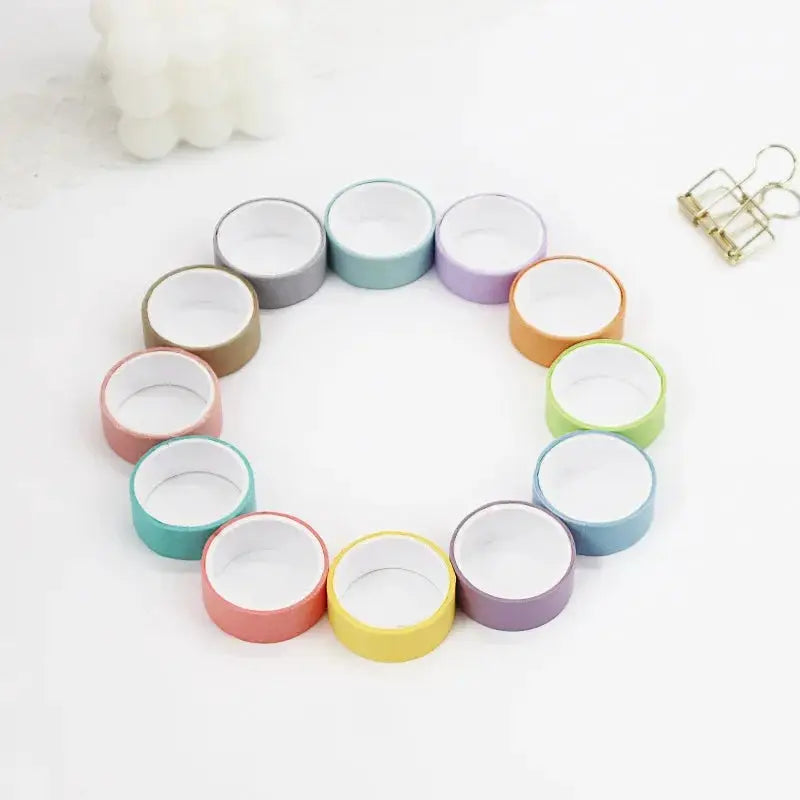 12 rolls of rainbow pastel masking washi tape arranged in a circle for scrapbooking and crafts