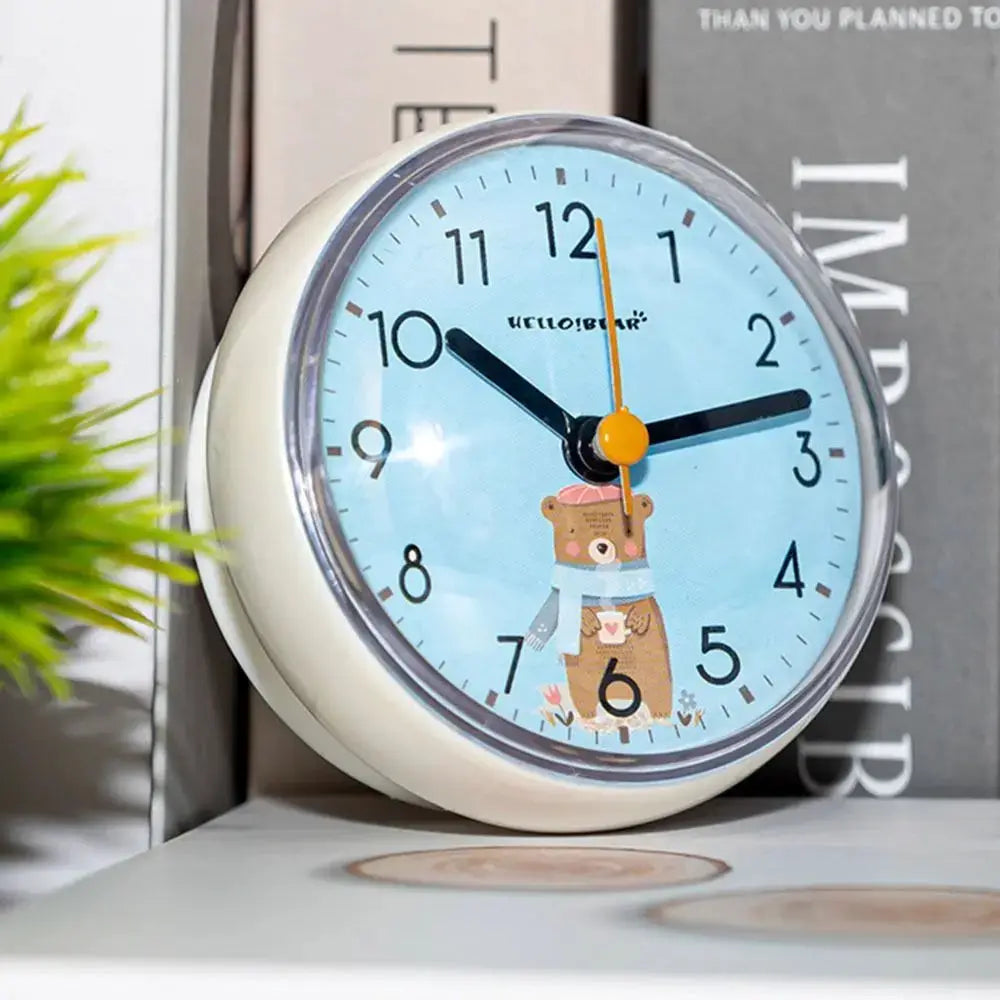 Mini round wall clock with light blue dial and bear illustration, white frame.