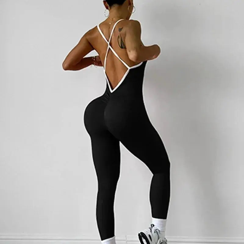 Women seamless sports jumpsuit, black ribbed bodysuit with white V-back straps.