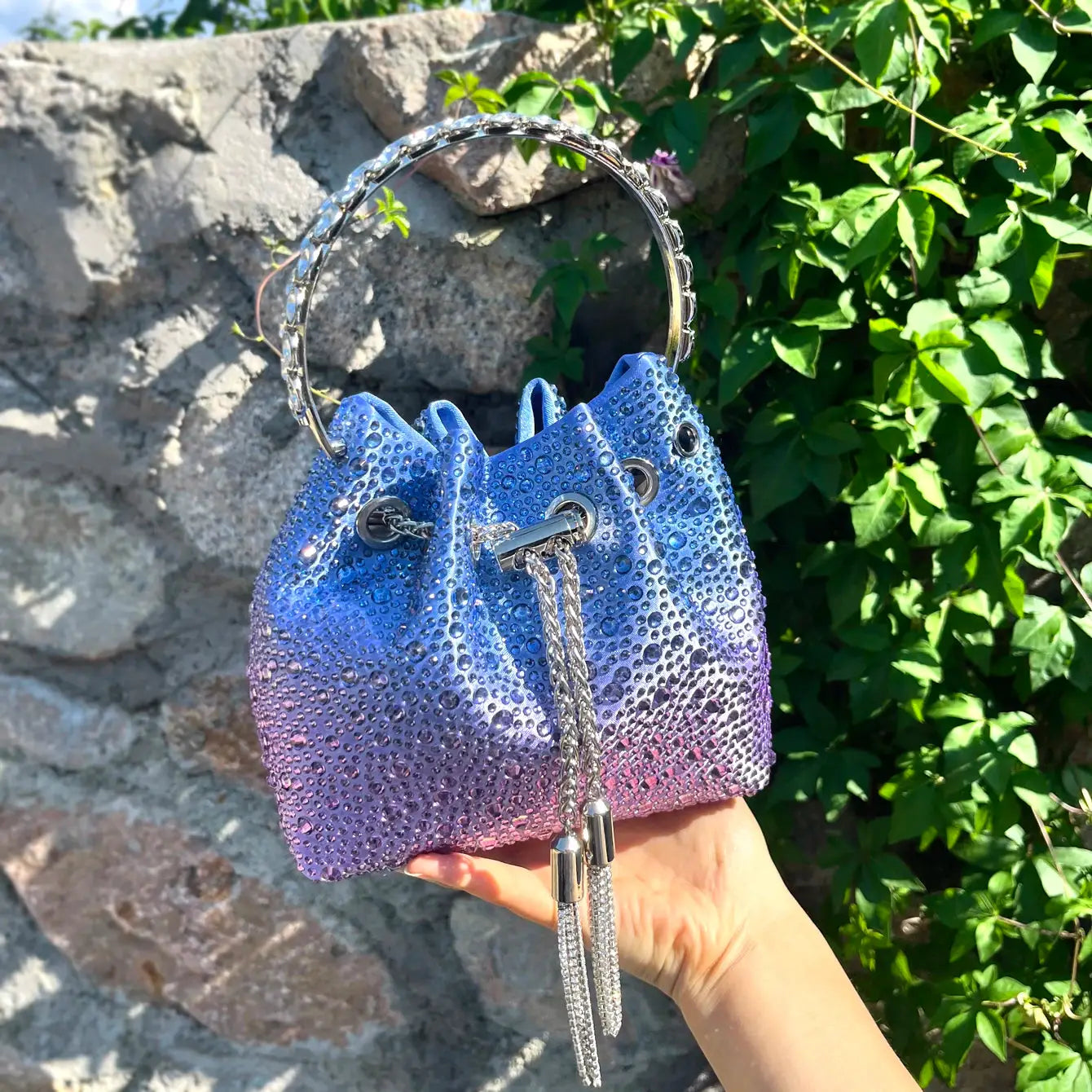 Rhinestone evening bucket bag with circular crystal handle in blue-purple gradient