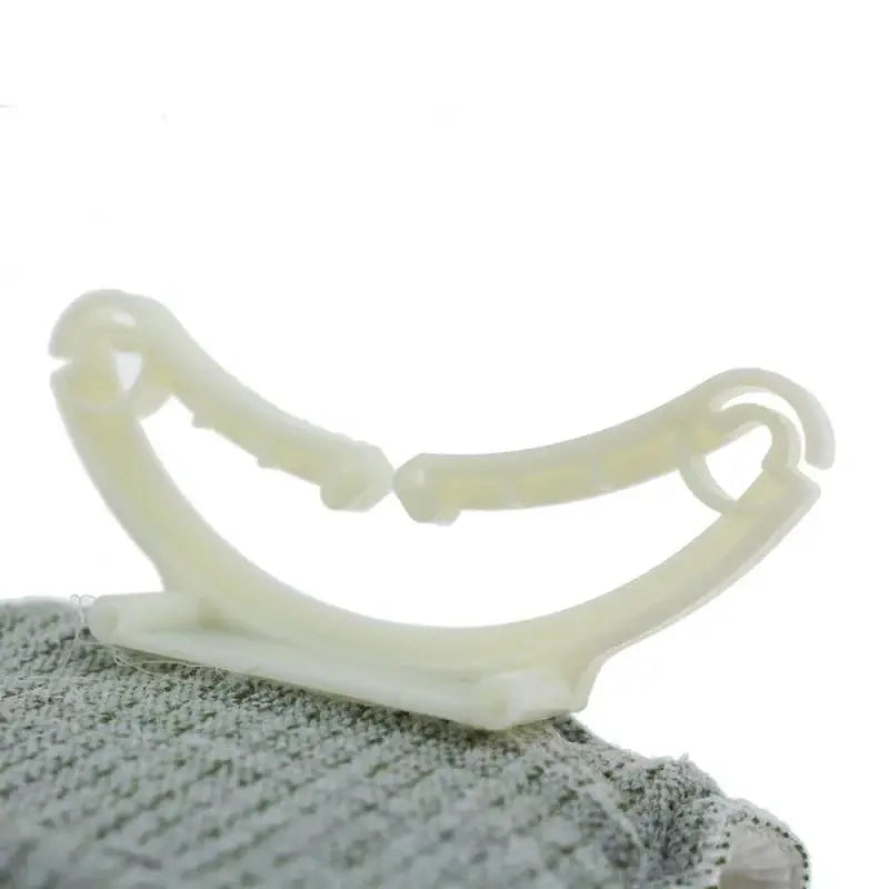 IFAK medical trauma kit Israeli Bandage accessory, white plastic curved device on fabric