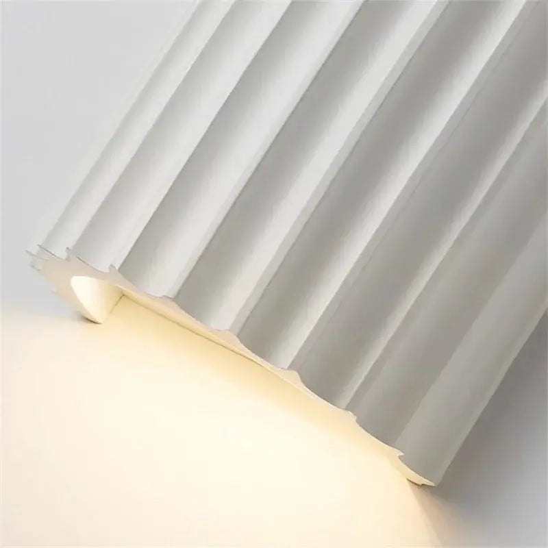 Nordic Modern Resin Wall Lamp by Simples Market; white resin wall light for bedroom or living room with warm glow.