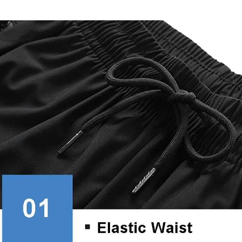 Black sports shorts with elastic waistband and drawstring, ideal for running and gym.