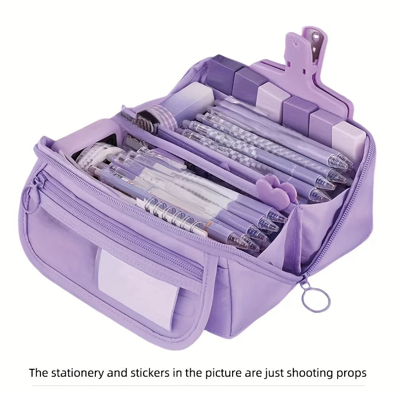 Purple large-capacity pencil case with multiple compartments, opened to reveal pens and pencils.