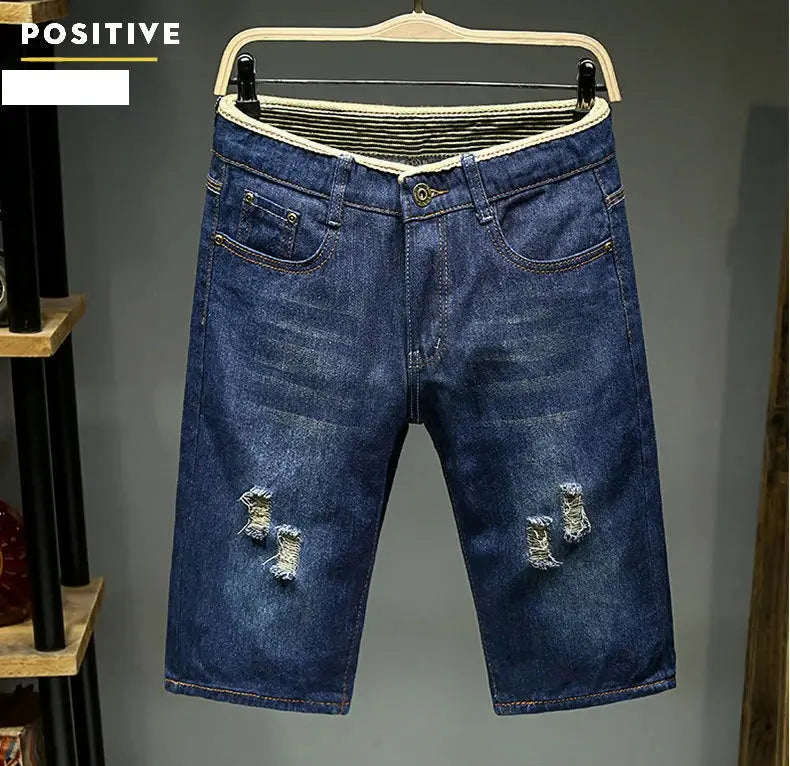 Men's light blue denim shorts with ripped knees, slim fit and elastic waistband