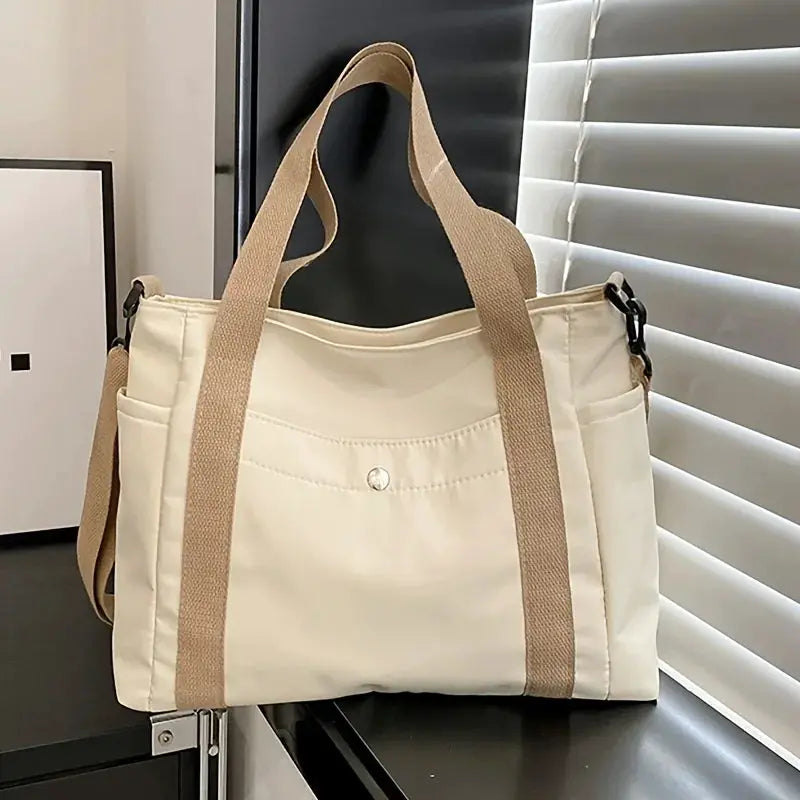 Large Capacity Nylon Crossbody Bag, cream color with removable strap and beige handles.