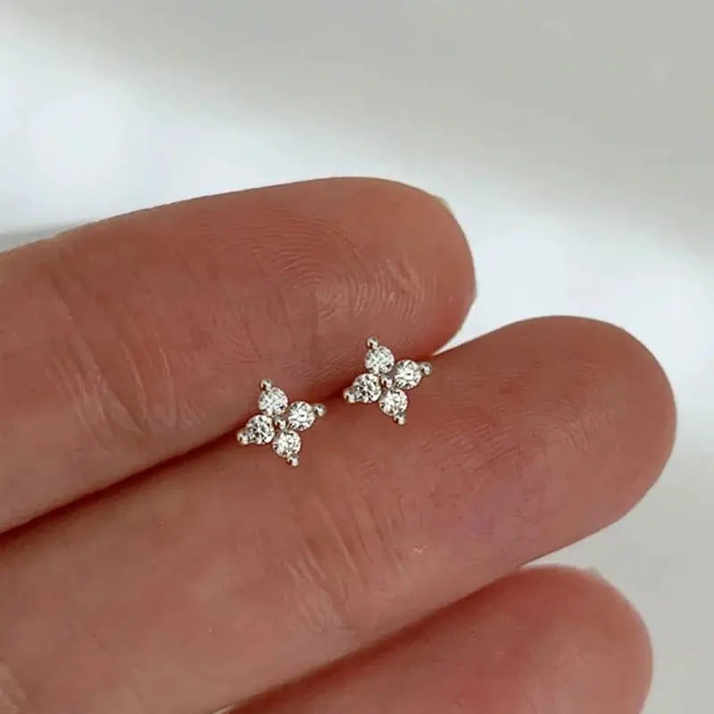 Pair of silver-tone flower-shaped cubic zirconia stud earrings with four-petal design