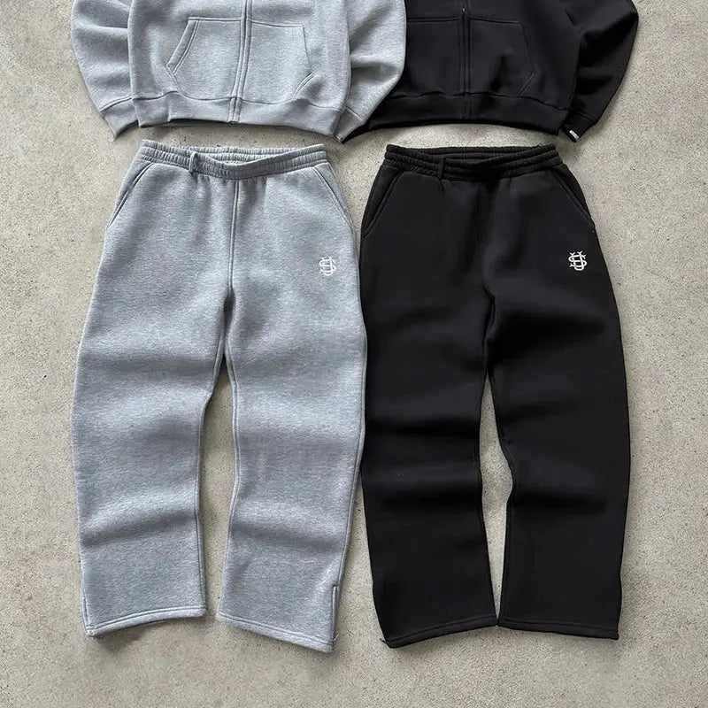 Two pairs of sweatpants by Simples Market; gray and black high-waist joggers with small logo