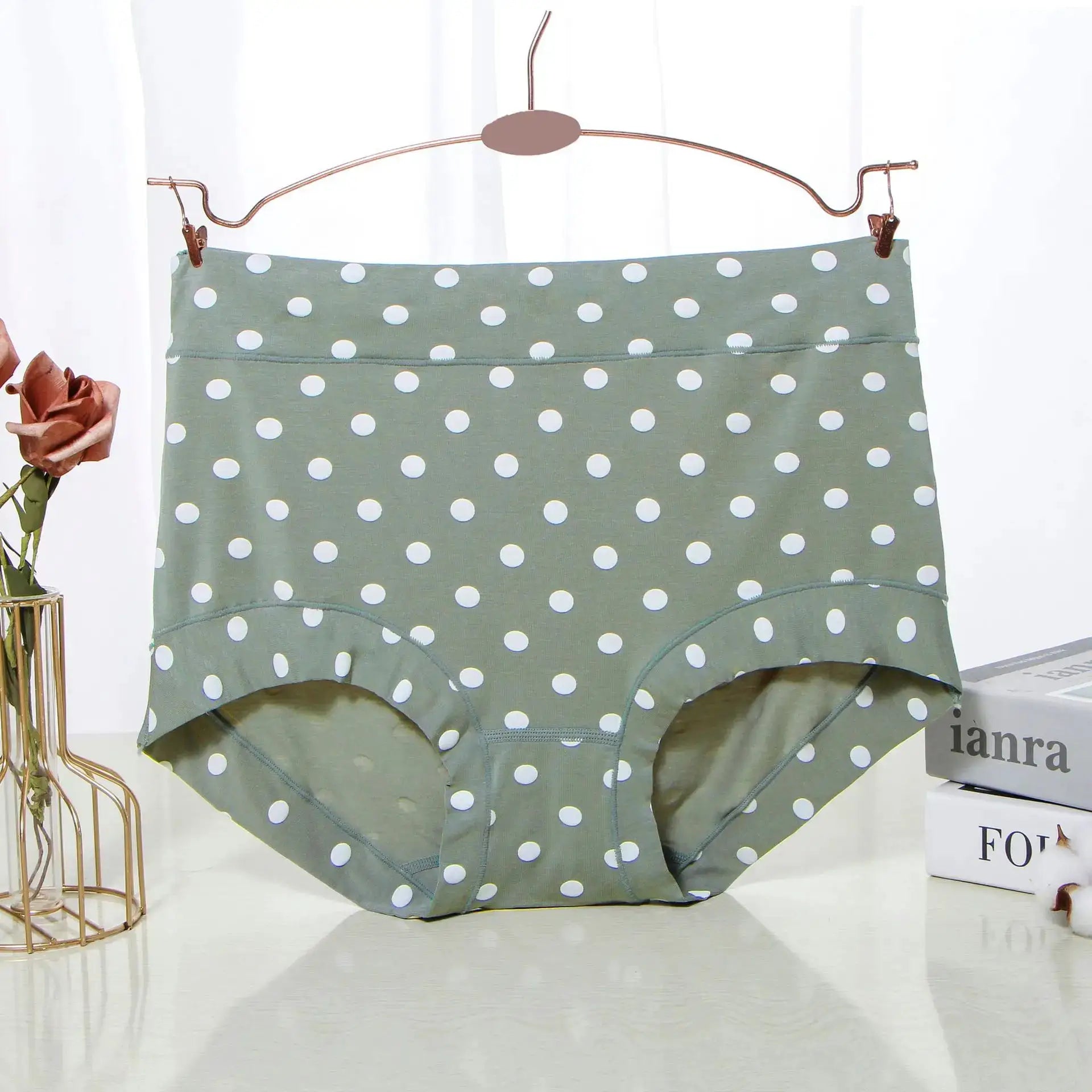 Panties by Simples Market; green polka-dot high-waist briefs in modal fabric on a hanger with decor visible