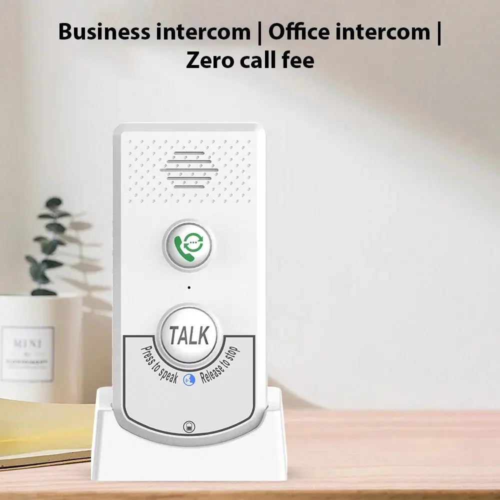 White wireless home intercom on a desk stand with TALK button and green call icon.