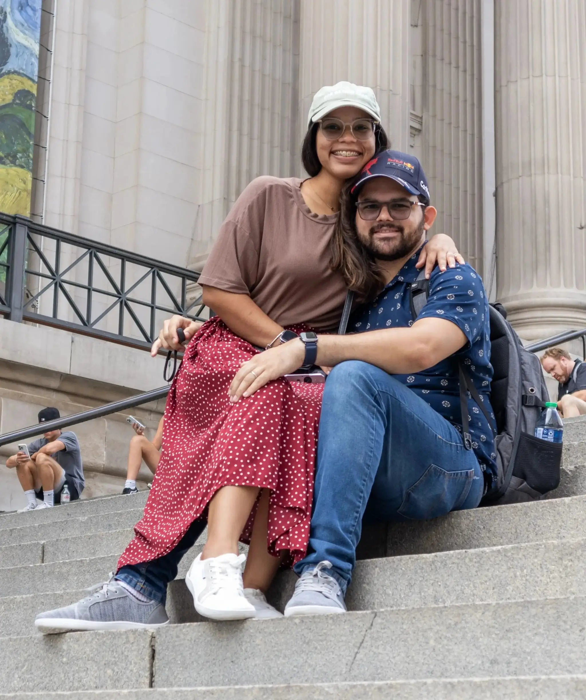 HOBIBEAR unisex wide-toe barefoot shoes on two people sitting on stone steps, white and gray sneakers visible