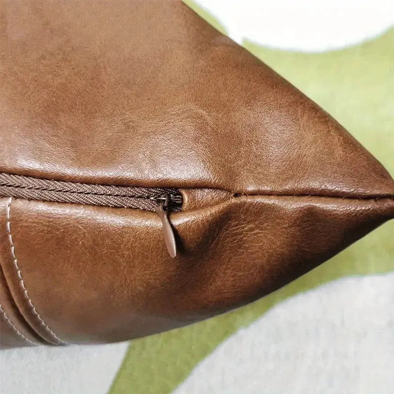 Throw pillow cover by Simples Market in brown faux leather with zipper closure