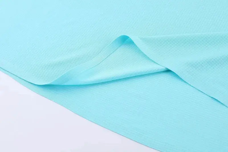 Athletic tank top in turquoise textured fabric; sleeveless performance singlet close-up