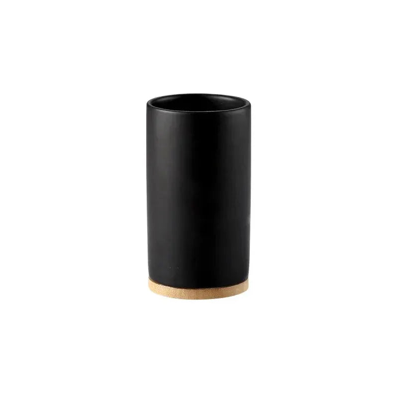 Ceramic bathroom tumbler, black with a cork base; part of a bathroom accessories set.