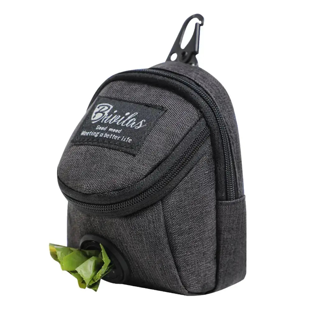 Dog treat pouch with built-in poop bag dispenser, dark gray fabric, portable.