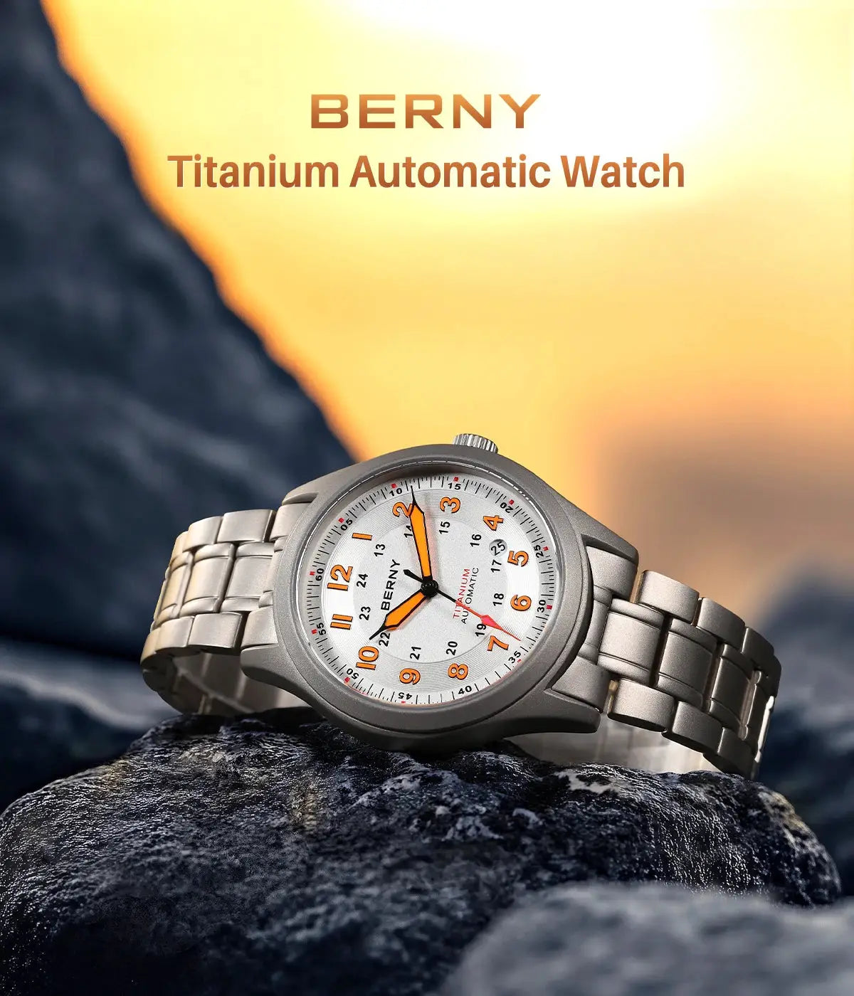 BERNY titanium automatic watch for men with white dial, orange numerals, and silver bracelet on a rock