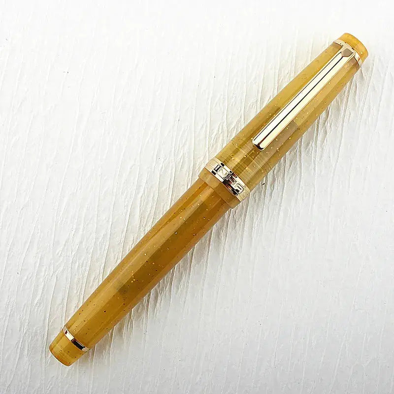 Jinhao 82 fountain pen in amber acrylic with gold trim and converter