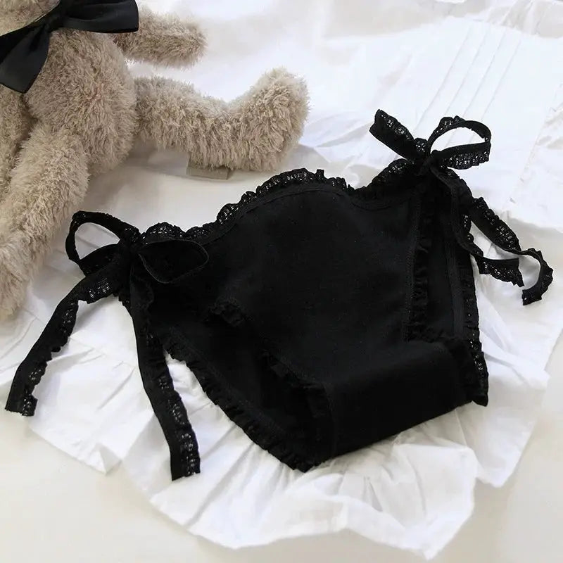 Alluring lace-up briefs, black low-waist women's panties with lace trim and bow-tie side ties.