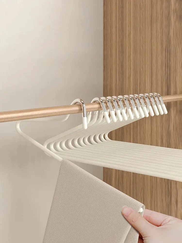 Simples Market 30pcs goose-shaped pant hangers with anti-slip clips on a wooden closet rod