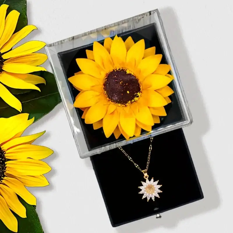 Sunflower pendant necklace in gold-tone chain, presented in a black jewelry gift box by Simples Market