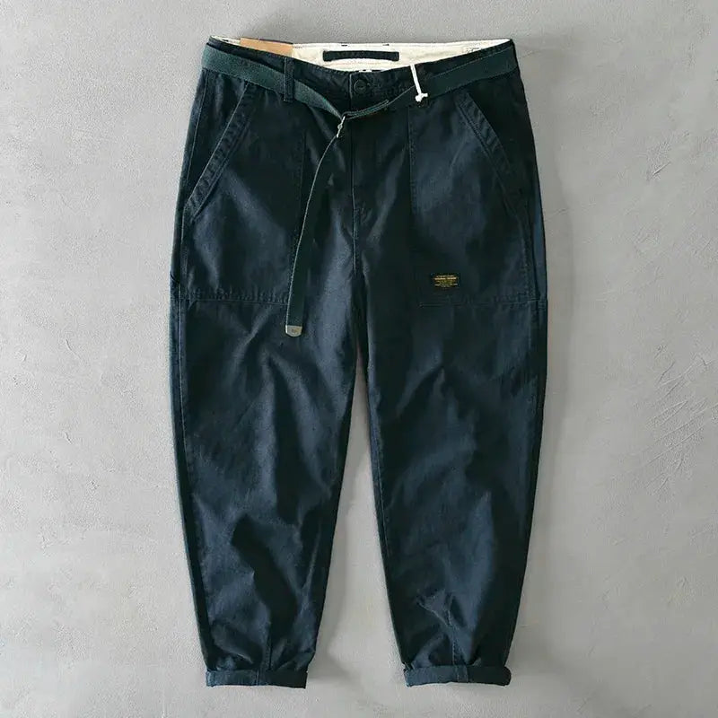 Men's cotton cargo pants with large pockets, drawstring waist, and cuffed hems in dark navy