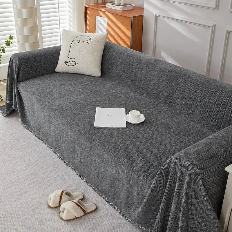 Simples Market couch cover in dark gray chenille with herringbone texture and fringe
