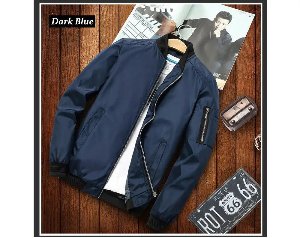 Dark blue men's windbreaker jacket with zip front and side pockets, ribbed cuffs and hem.