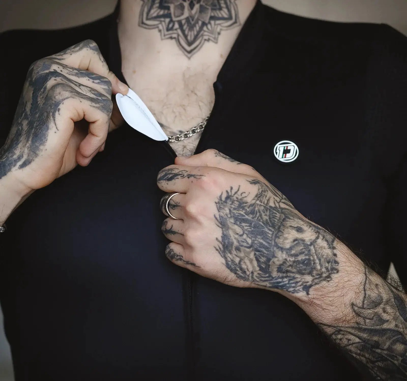 DAREVIE cycling jersey, black breathable SPF 50+ top with front zipper and round logo badge
