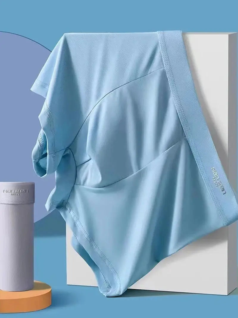Men's light-blue ice-silk boxer shorts, breathable and ultra-thin fabric, displayed draped over a white block