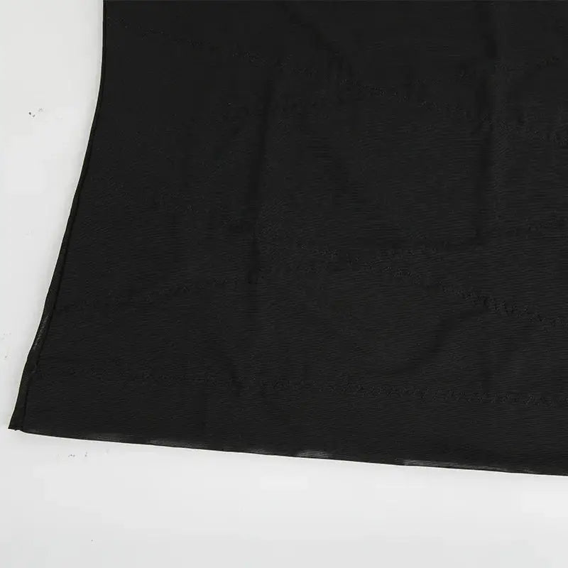 Men's black shapewear tank top fabric close-up with stitching details.