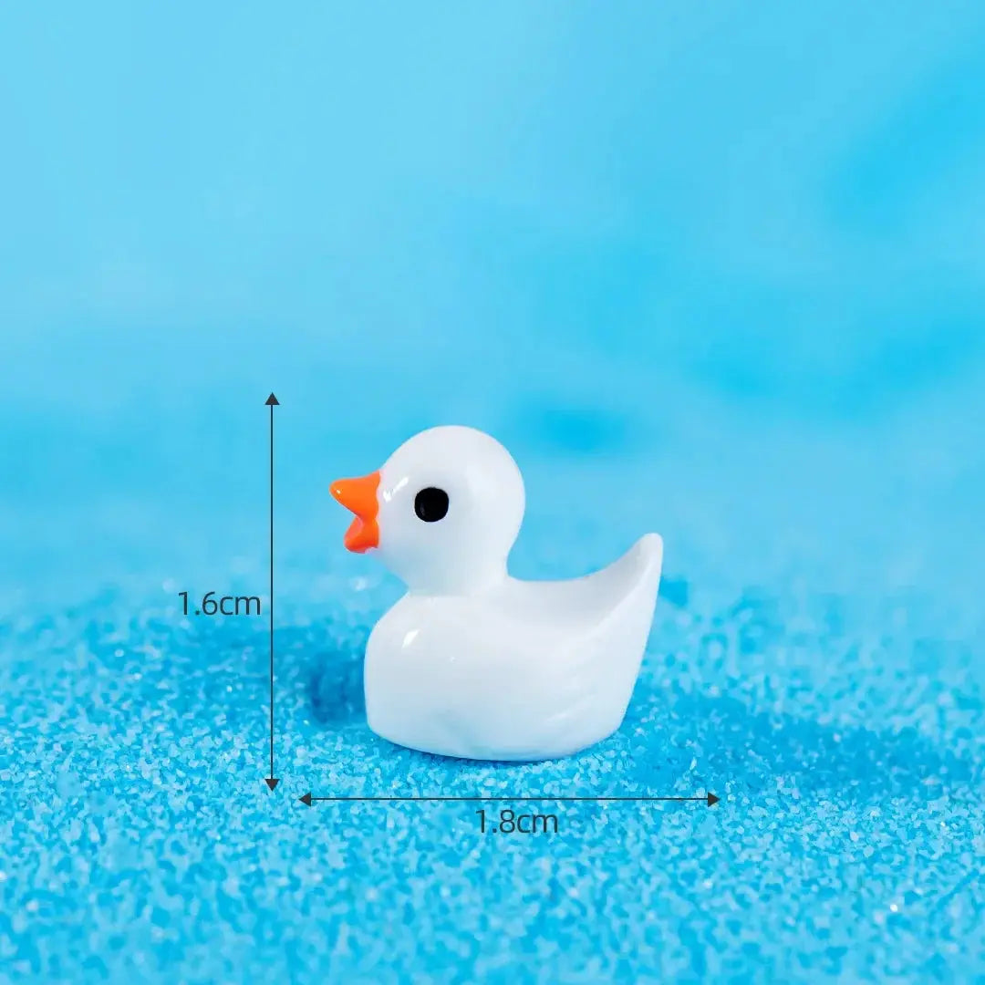 Mini resin duck figurine, white with orange beak, about 1.8 cm long