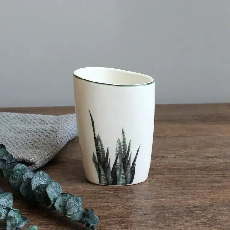 White ceramic bathroom cup with green botanical motif; Simples Market
