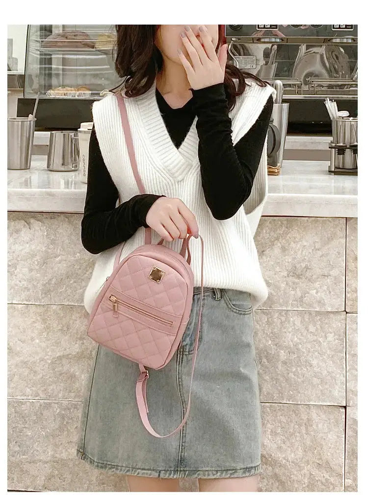 Backpack, pink quilted mini with gold hardware and front zip pocket