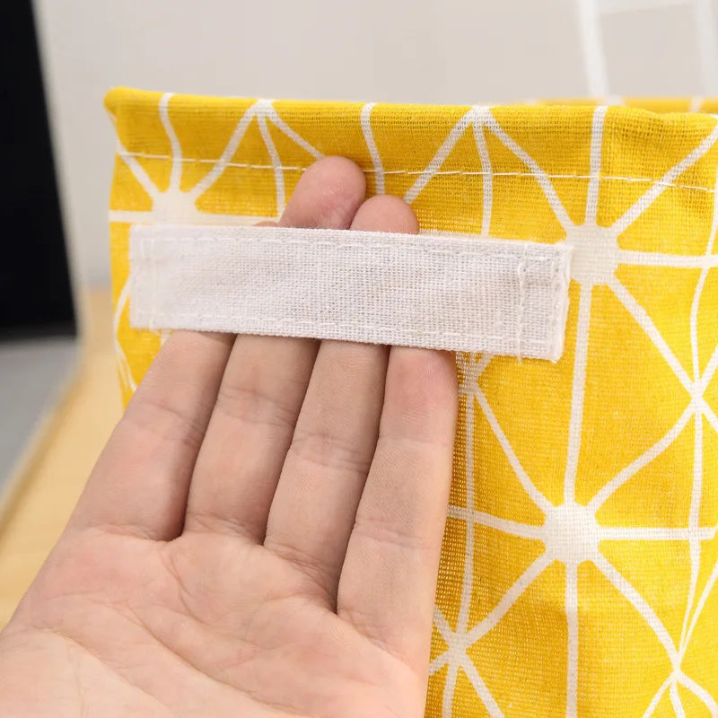 Linen desktop storage basket in yellow with white geometric pattern and a white Velcro strap