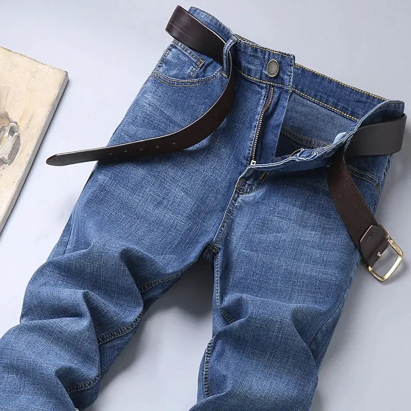 Men's blue denim jeans with brown belt, straight-leg casual workwear style